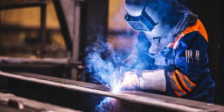 worker welding in a factory