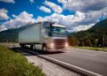fuel truck rushes down the highway in the background the alps truck car in motion blur
